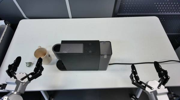 Robot arms at a capsule coffee machine